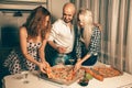 Happy students joy a home party with pizza and alcohol