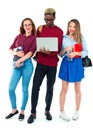 Happy students standing and smiling with books, laptop and bags Royalty Free Stock Photo