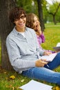 Happy students studying into autumn park