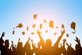 Happy students throwing graduation caps in the Air