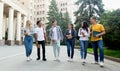 Happy students walking outside the university building Royalty Free Stock Photo