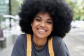 Happy African teen hipster girl with Afro hair looking at camera, headshot. Royalty Free Stock Photo