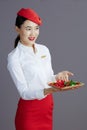 happy stylish asian female air hostess isolated on grey Royalty Free Stock Photo