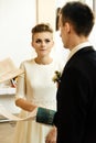 Happy stylish bride and elegant groom exchanging vows at catholic wedding ceremony at church Royalty Free Stock Photo