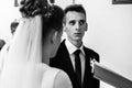 Happy stylish bride and elegant groom exchanging vows at catholic wedding ceremony at church Royalty Free Stock Photo