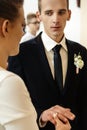 Happy stylish bride and elegant groom exchanging wedding rings at ceremony at church Royalty Free Stock Photo