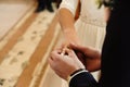 Happy stylish bride and elegant groom exchanging wedding rings at ceremony at church Royalty Free Stock Photo