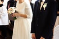 Happy stylish bride and elegant groom sitting at catholic wedding ceremony at church Royalty Free Stock Photo