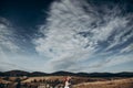 Happy stylish bride and groom kissing in mountains in sunset light. gorgeous boho newlywed couple embracing, true feelings.