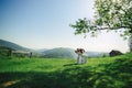 Happy stylish bride and groom running and having fun in mountains on summer sunny day. gorgeous newlywed couple laughing, true