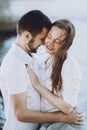 Happy stylish couple in love hugging on the beach in summer cit Royalty Free Stock Photo