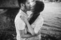 Happy stylish couple in love hugging on the beach in summer cit Royalty Free Stock Photo