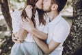 Happy stylish couple in love hugging and kissing in summer park Royalty Free Stock Photo