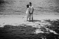 Happy stylish couple in love kissing on the beach in summer city Royalty Free Stock Photo