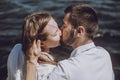 Happy stylish couple in love kissing on the beach in summer city Royalty Free Stock Photo