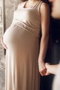 happy stylish family expecting for a baby. pregnant woman holding her belly with child and hands with her husband. tender moments Royalty Free Stock Photo