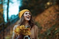 Happy stylish female in brown coat and yellow hat Royalty Free Stock Photo