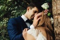 Happy stylish groom looking with tender at his gorgeous bride in Royalty Free Stock Photo