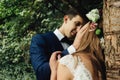 Happy stylish groom looking with tender at his gorgeous bride in Royalty Free Stock Photo