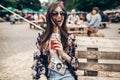 Happy stylish hipster woman in sunglasses with lemonade, smiling