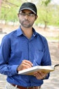 Happy stylish indian young businessman reading book outdoor