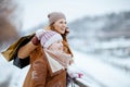 happy stylish mother and child in coat, hat, scarf and mittens Royalty Free Stock Photo