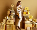 Happy stylish shopper woman with present boxes counting cash