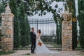 Happy stylish smiling couple walking in Tuscany, Italy on their wedding day. The bride and groom walk down the street by Royalty Free Stock Photo