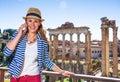 Happy stylish traveller woman in Rome, Italy using cell phone Royalty Free Stock Photo