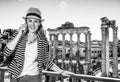 Happy stylish traveller woman in Rome, Italy using cell phone Royalty Free Stock Photo