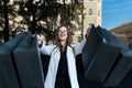 Happy stylish woman with black bags after successful shopping on street. Girl shopaholic. Black Friday, sale, discount Royalty Free Stock Photo