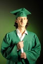 Happy succesful man on his graduation day in green