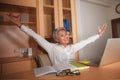 Happy and successful attractive middle aged Asian woman working at office laptop computer desk excited and cheerful celebrating Royalty Free Stock Photo