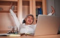 Happy and successful attractive middle aged Asian woman working at office laptop computer desk excited and cheerful celebrating Royalty Free Stock Photo