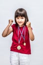 Happy successful boyish child with medals willing to win award