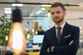 Happy successful business leader posing while his team in background Royalty Free Stock Photo