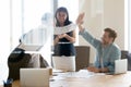 Happy successful business men giving high five at team meeting Royalty Free Stock Photo