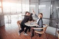 Happy successful business team giving a high fives gesture as they laugh and cheer their success Royalty Free Stock Photo