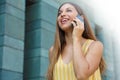 Happy successful business woman walking in the street and talking with mobile phone Royalty Free Stock Photo