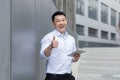 Happy and successful businessman asian looking at camera and thumbs up Royalty Free Stock Photo