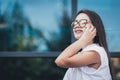 Happy successful businesswoman calling with cell telephone outside, smiling female entrepreneur managing business