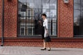 happy successful businesswoman checks email on smartphone during a lunch break outside office, manager uses mobile phone Royalty Free Stock Photo