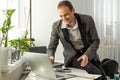 Happy successful busy caucasian man in a suit, company employee, top manager, boss, sitting in the office, talking on