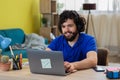 Happy successful confident young hispanic man in headphones, call center employee or freelancer, works remotely on Royalty Free Stock Photo