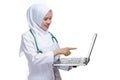 Happy successful female Asian Muslim nurse or doctor, smiling confidently with pointing the laptop screen Royalty Free Stock Photo