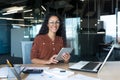 Happy and successful hispanic woman working inside modern office building, business woman using tablet computer smiling Royalty Free Stock Photo