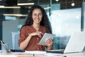 Happy and successful hispanic woman working inside modern office building, business woman using tablet computer smiling Royalty Free Stock Photo