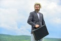 Happy and successful man hold money case. bearded man show office briefcase. good business deal. successful business