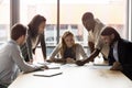 Happy successful mixed race business team discussing project ideas. Royalty Free Stock Photo