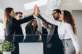 Happy successful multiracial business team giving a high fives gesture as they laugh and cheer their success Royalty Free Stock Photo